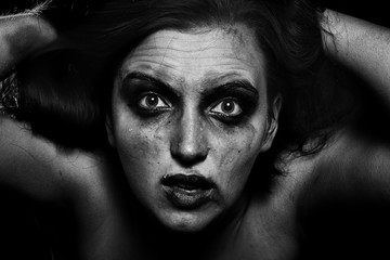 sad woman with smeared cosmetics on dark background, monochrome