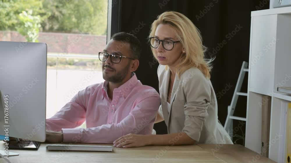 Poster professional business team discussing project looking on screen computer. mixed race man and woman w