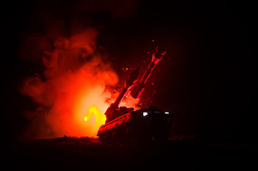 Rocket launch with fire clouds. Battle scene with rocket Missiles with Warhead Aimed at Gloomy Sky at night. Rocket vehicle on War Backgound.