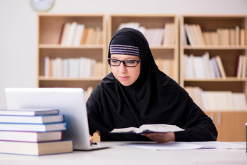 Muslim girl in hijab studying preparing for exams