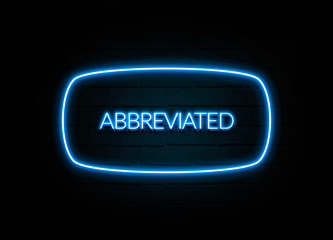 Abbreviated  - colorful Neon Sign on brickwall