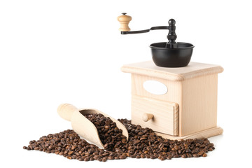 Coffee beans in wooden scoop with coffee bean grinder