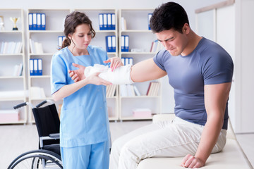 Fototapeta premium Doctor and patient during check-up for injury in hospital