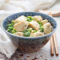 Fried chicken with green peas in cream sauce, served with rice, square format
