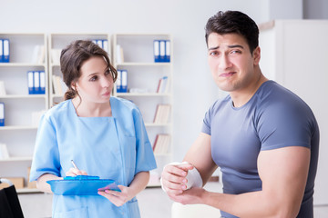 Fototapeta premium Doctor and patient during check-up for injury in hospital