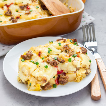 Egg casserole with potatoes, sausage and pepper, in baking dish, square format