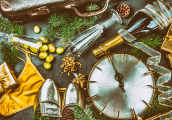 Fototapeta na wymiar LATIN AMERICAN AND SPANISH NEW YEAR TRADITIONS. empty suitcase, lentil spoon, yellow interior clothes, gold ring in champagne, 12 grapes, money in shoe. Christmas background
