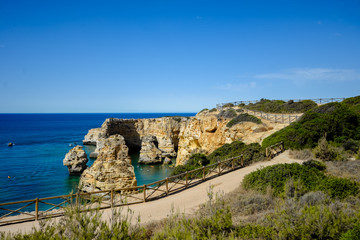 Praia da Marinha, beautiful sea view with sandy beach among rocks and cliffs in Algarve, Portugal. Sunny outdoors background