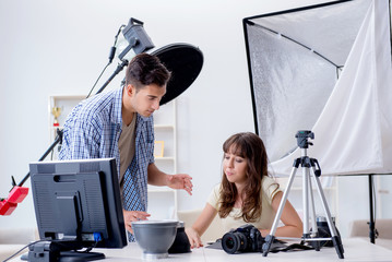Young photographer working in photo studio