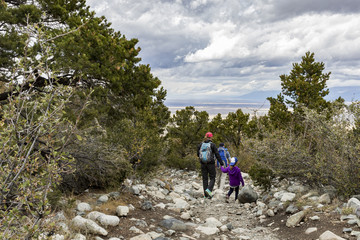 Fototapeta premium A family hiking in the mountains above Great Sand Dunes National Park in Colorado.