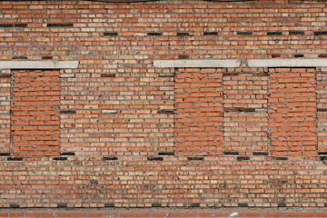 Old brick wall with walled windows
