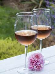 Glasses of rosé next to pink flowers
