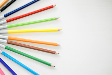 Wooden Pencil Colours are putting on wooden white table.