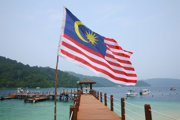 Malaysian flag flying above the jetty of Palau Manukan Island near Kota Kinabalu, Borneo, Malaysia