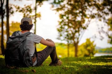 Man traveler traveling walking with backpack at the jungle on holiday at weekend on background nature view