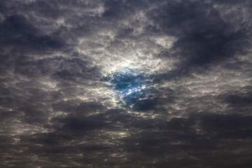 Blauer Himmel zwischen dunklen Wolken