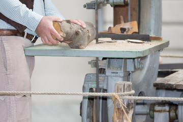 Asti, Italy - September 10, 2017: carpenter cuts a trunk of a tree with a ribbon saw