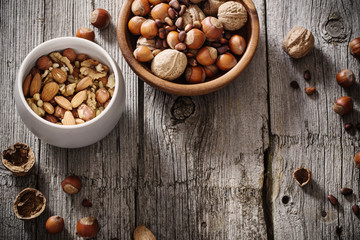 Mixed nuts on old wooden background