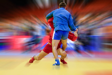 Sambo fighter attacking his opponent with leg technique