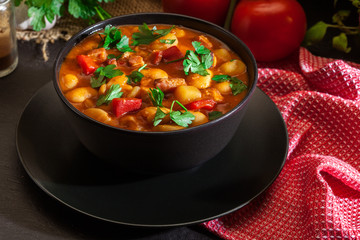 White bean soup with potatoes, tomatoes, paprika, and bacon