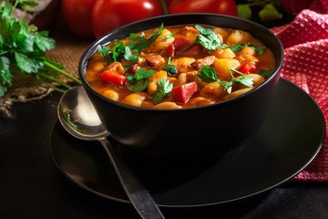 White bean soup with potatoes, tomatoes, paprika, and bacon