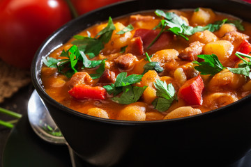White bean soup with potatoes, tomatoes, paprika, and bacon