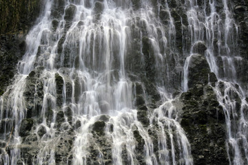 Water falling in Karekare Falls New Zealand