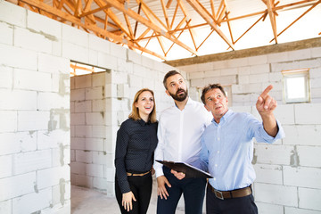 Architects and civil engineer at the construction site.