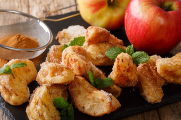 Organic food: sweet apples fried with cinnamon, sugar and mint closeup on the table. horizontal