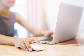 Fototapeta premium people woman freelance is working business on the table a new project on laptop computer using mouse and typing keyboard on social network while relaxing at home.