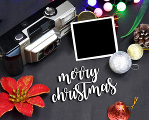Christmas celebration background with camera and photos on black background merry Christmas