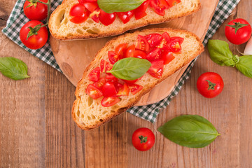 Bruschetta bread with basil and chopped tomatoes.