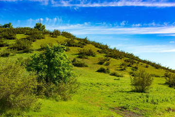 Fototapeta na wymiar Green hills and blue sky