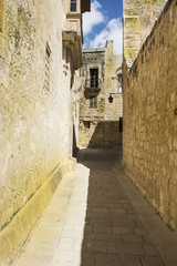 Street with traditional maltese buildings in Mdina