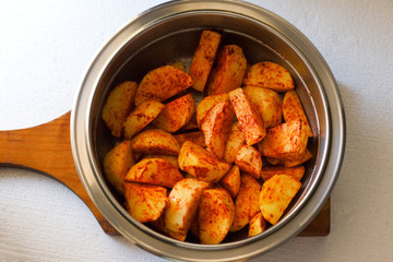 Perfect roasted potatoes with spices and herbs on wood board .