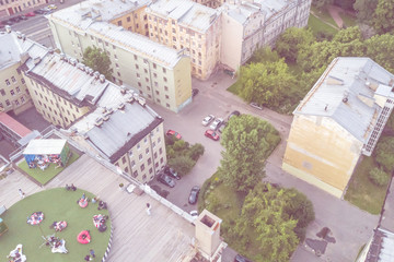 Top view of the people relax on the roof of a multistory building. Toned