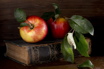 Apples fruit autumn green leaves vitamins book wooden table still life