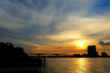 Fototapeta na wymiar Scenery of Sunset at Chaophraya River at Asiatique Market Pier. Chaophraya River is the major river in Bangkok, Thailand.