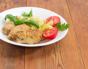 Meat roulades with filling, spiral pasta and tomato