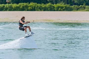 Cool girl on wakeboard stunt platform