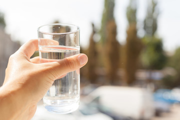 Woman holding a glass of water, close-up