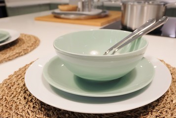 Fototapeta na wymiar Set of Porcelain Plates, Bowls and Silverware