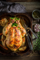Tasty roasted chicken with spices and vegetables