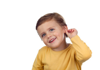Adorable small child two years old touching his ear