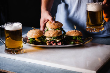 Food Table bar eating hamburger drinking beer glass eating party food table person 