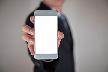 Businessman hold and show white screen of smartphone display for input free space as advertising concept.
