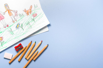 Children's drawing and color pencils top view