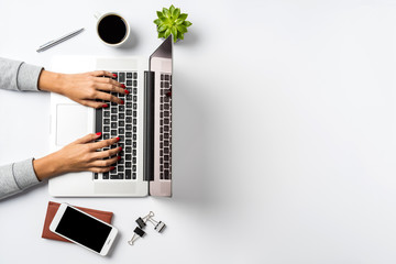 Fototapeta na wymiar Female hands working on modern laptop. Office desktop on white background