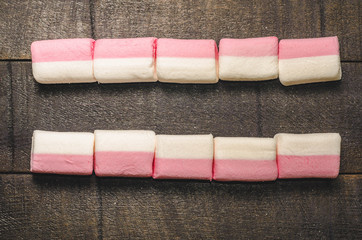 Pink marshmallows on a dark background with copyspace