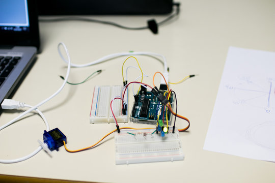 Circuit for a servomotor built for educational purposes. A programmed microcontroller manages the position of a servomotor, on a sheet are indicated the rotation angles of the servomotor arm